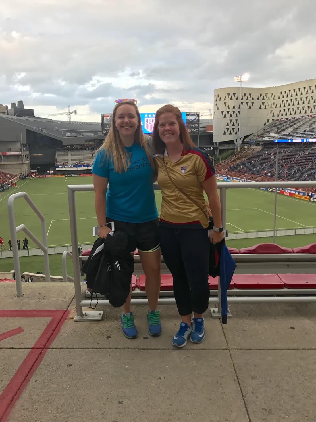 Evelyn and JoBeth standing together in the stands at a US Women's National Team soccer game